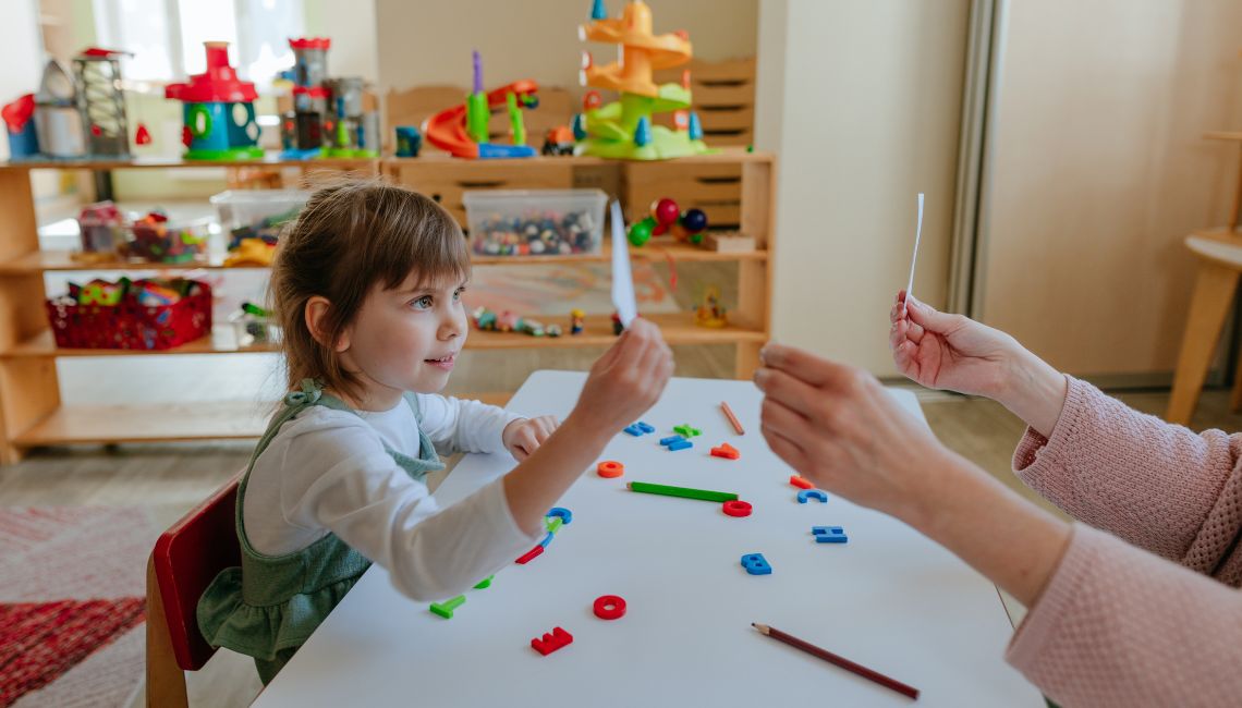 Child in therapy holding flash cards