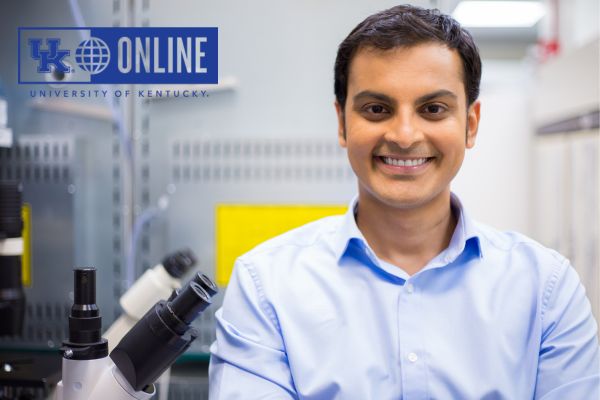 man next to microscope