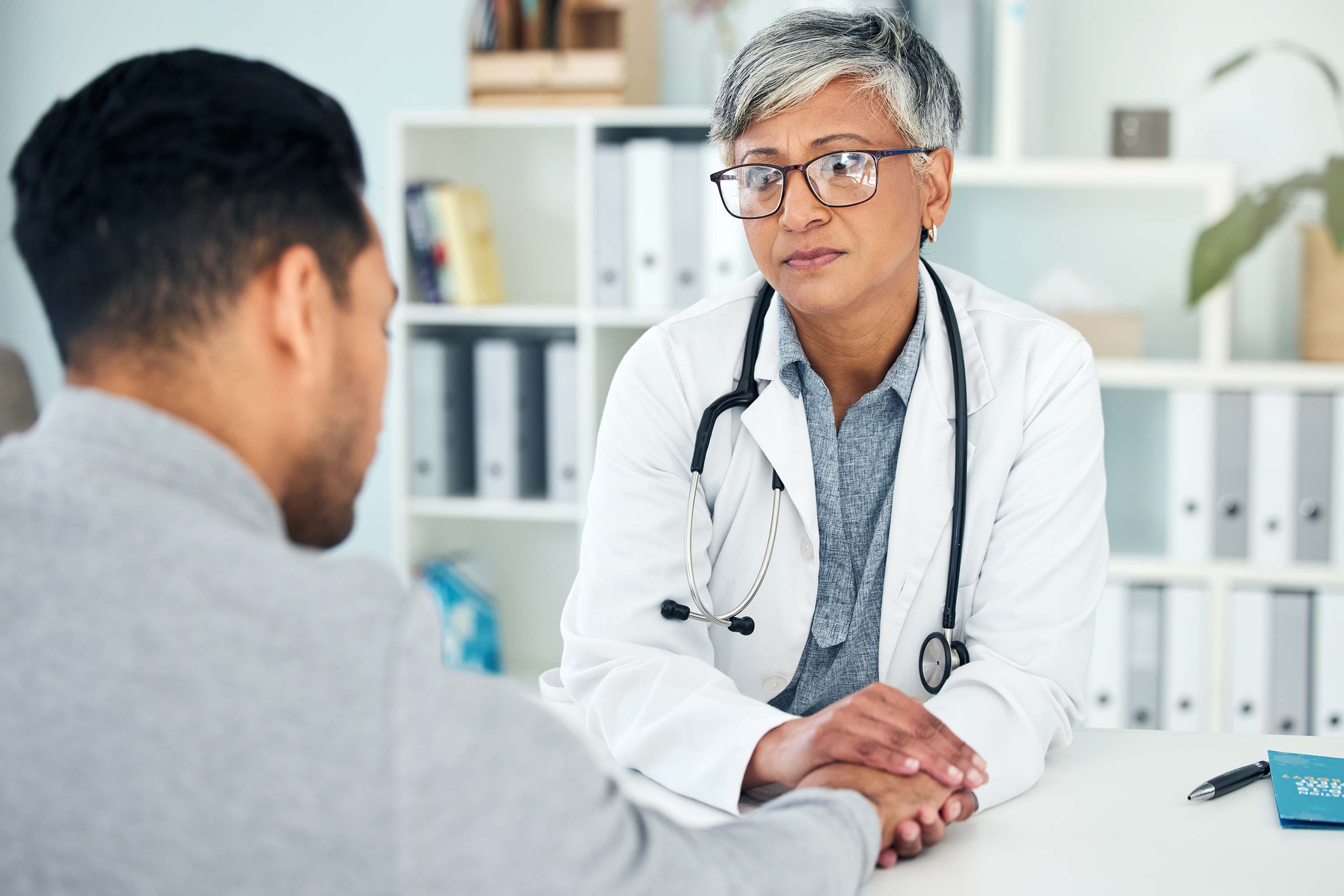 Empathy, sad and holding hands with doctor and patient in hospital for consulting