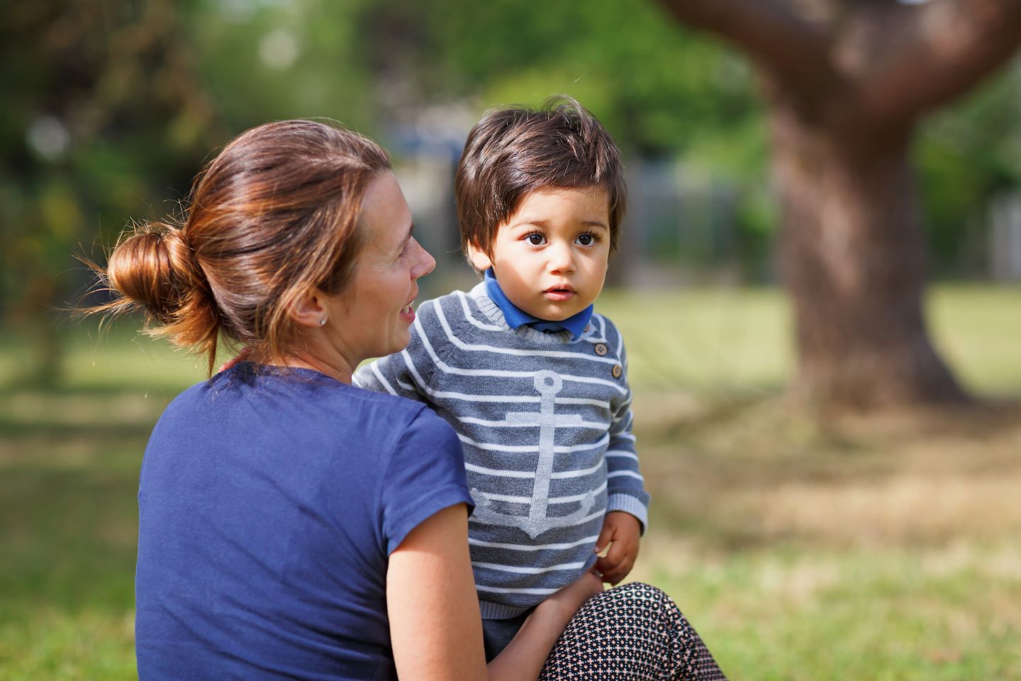 Woman playing with child in park