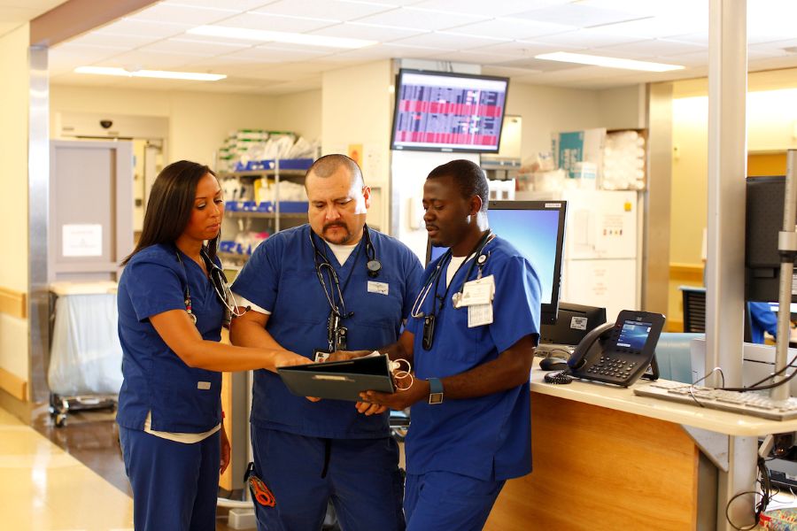 Three nurses at a nursing station