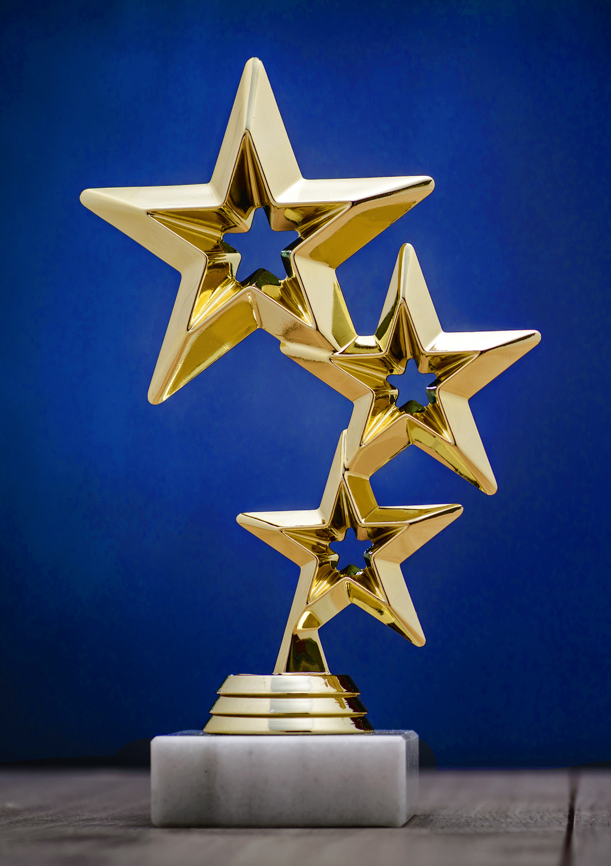 image of an star-shaped trophy against a blue background