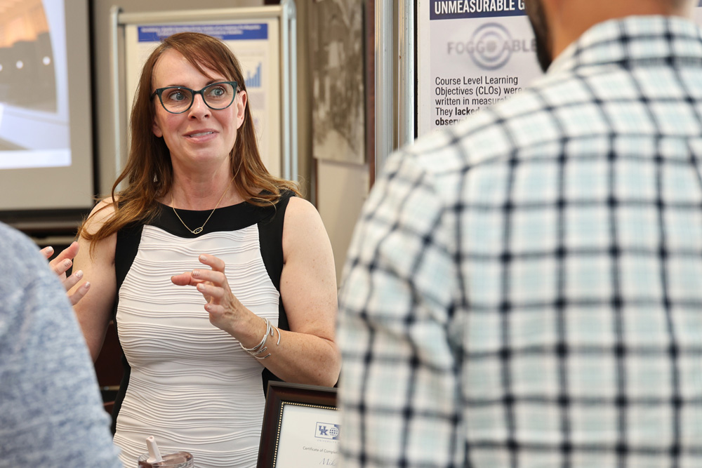 Photo of Mika Pryor sharing her experience re-designing MAT 247 during the Course Quality Design Program Showcase.