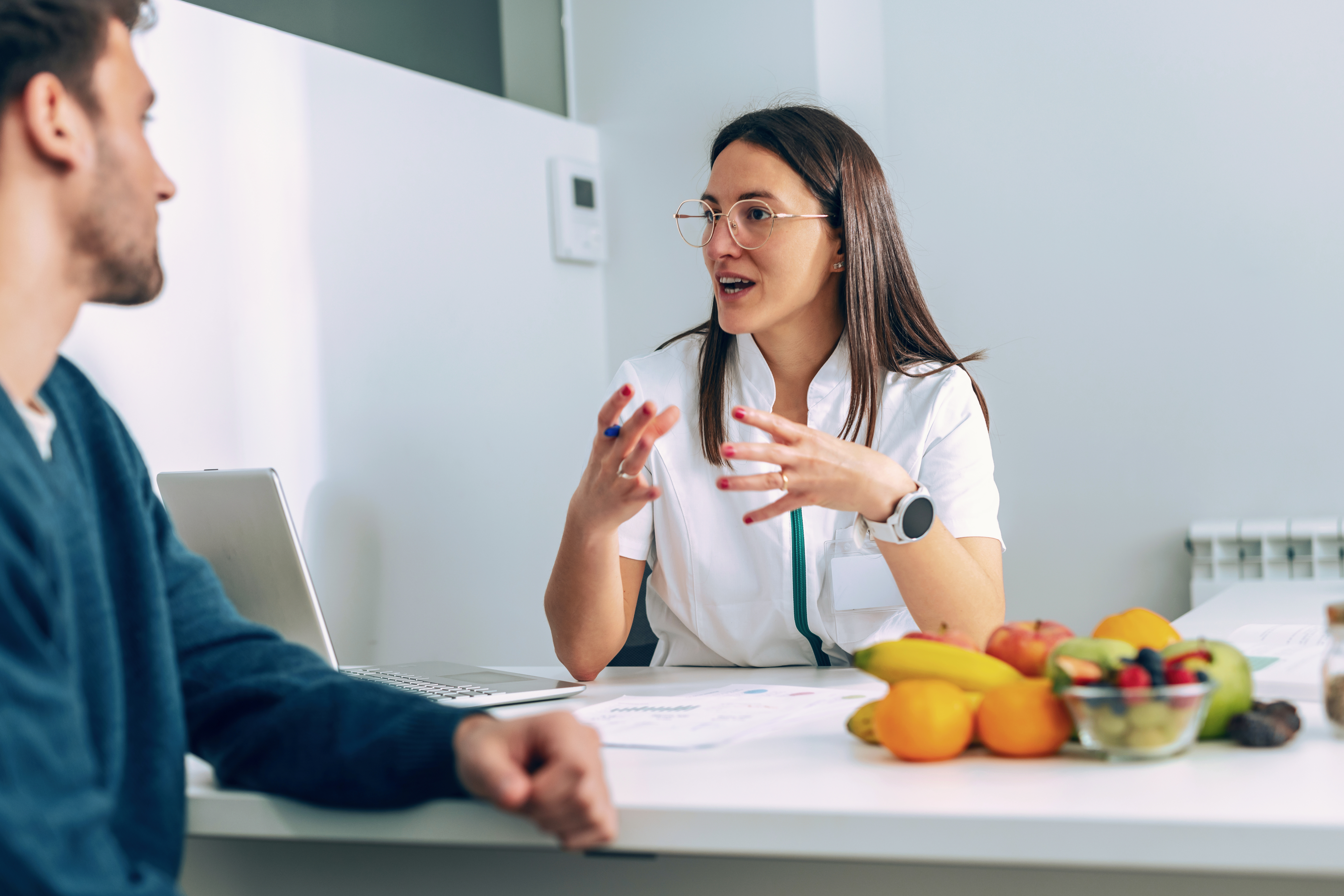 A dietician consulting with a patient in a healthcare setting.