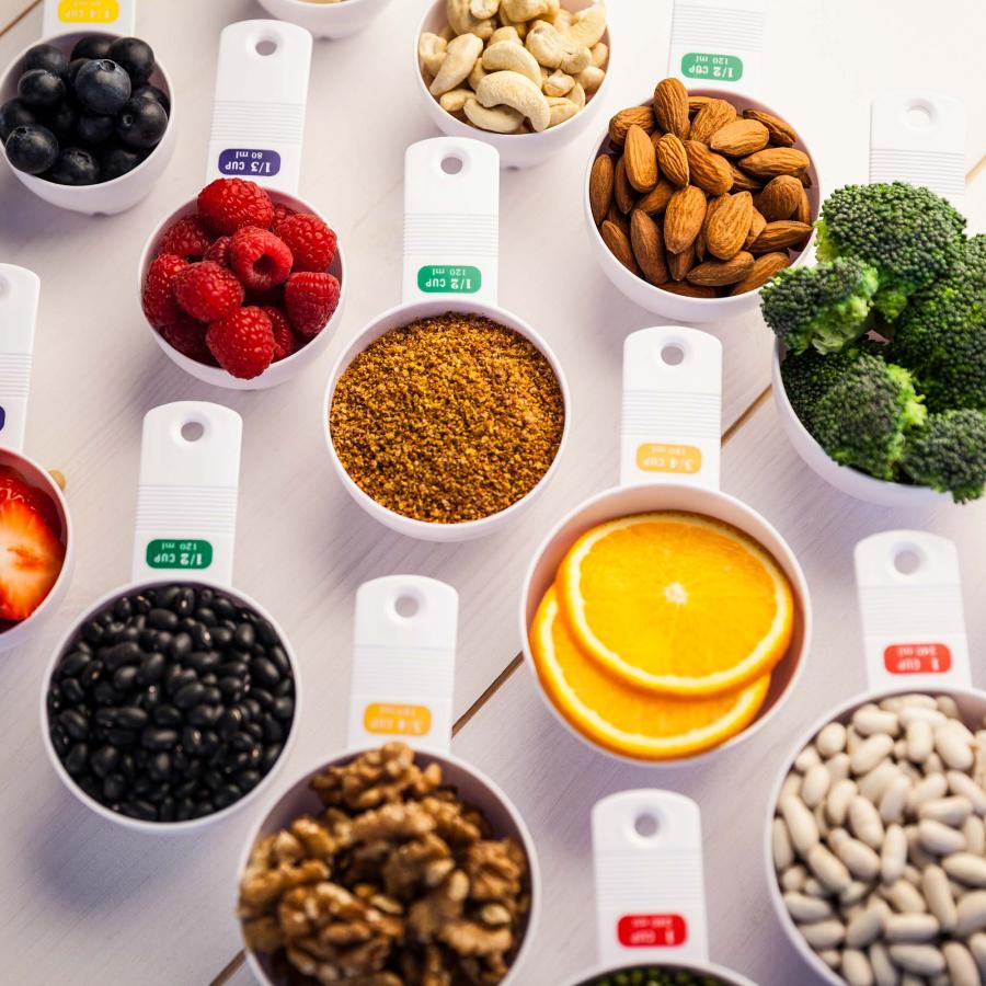 Portion cups of healthy ingredients on wooden table